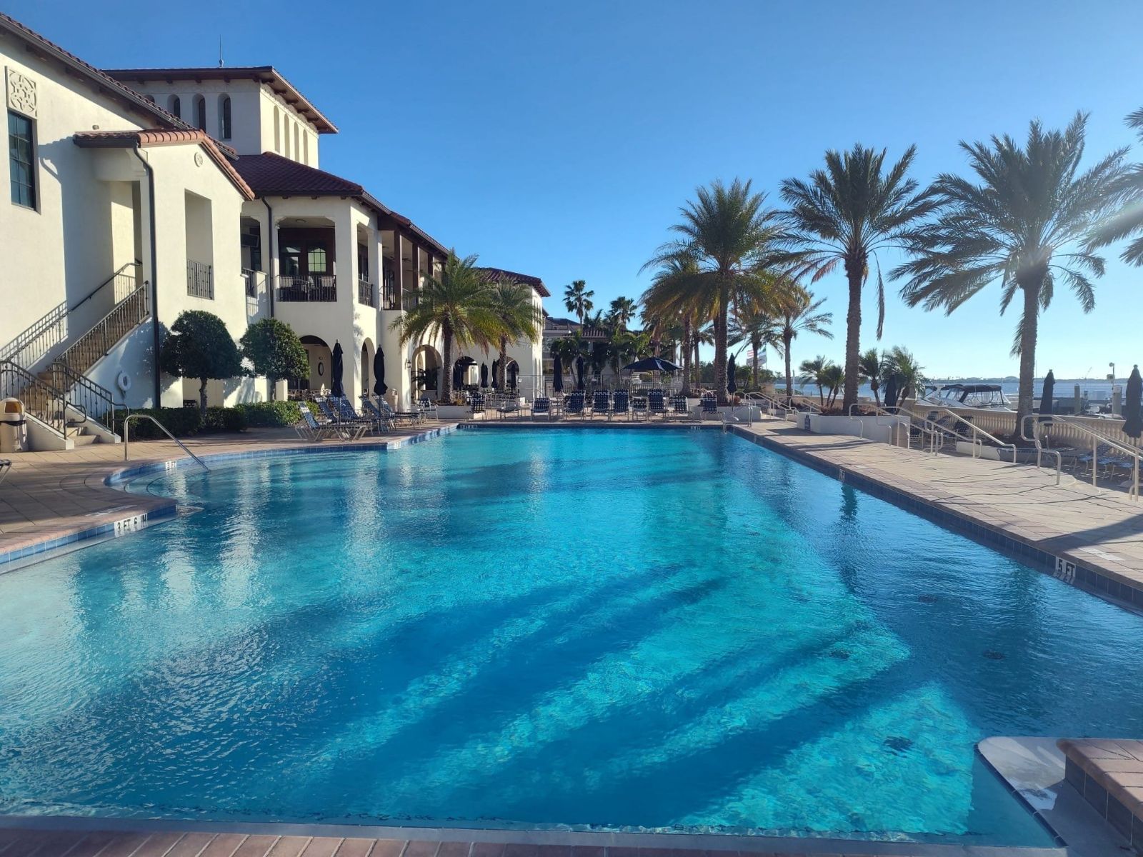 Commercial swimming pool after professional cleaning with crystal clear water and restored finish